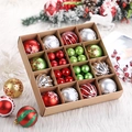 Detail of multi-colored Christmas ornaments with glitter and patterns in a rustic gift box - Red Green Silver