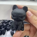 Handheld matte black obsidian French Bulldog puppy figurine showing detailed craftsmanship - Mad Dog
