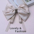 Champagne gold satin bow hair clip with long ribbons and elegant silk texture - Beige