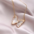 Elegant gold butterfly crystal necklace for women on light purple silk background - White