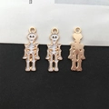 White enamel skull charms in gold metal for DIY jewelry making with front and back view - White Skeleton 10x25mm (15135)
