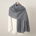 Detail of soft grey linen cotton scarf draped on a wooden hanger over a white shirt - Dark Grey