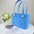 Close-up of light blue EVA beach bag with signature perforated holes and white buttons - Small / Sky Blue
