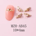 Detailed macro view of champagne heart nail charms with golden twisted metal frame - Gold Champagne Style (AB45) / 10 Pieces Pack