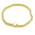 Detailed view of gold beaded bracelet featuring a white enamel star pendant on white background - White
