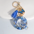 Letter Q keychain with royal blue shell resin, tassel, and gold butterfly charm - Letter Q