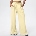 Detail of soft cream wide-leg trousers with drawstring waist and fluid drape texture - Light Yellow