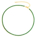 Flat lay of gold tennis necklace with green zircon stones and lobster clasp closure - Necklace