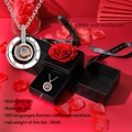 Close-up of a white gold necklace with 100 languages projection in a red rose gift box - White Gold Projection Necklace With Rose Double Door Gift Box