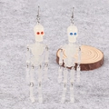 Luminous Halloween skull drop earrings in translucent white with red and blue eye accents - Gradient