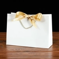 Elegant white gift paper bag with a golden satin bow and silver grey rope handles - Bowknot Decoration Style / 19x15x7cm / White