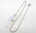 Detailed macro view of an opal hexagonal crystal pendant with a silver metal chain - Opalite
