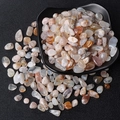 Polished natural crystal stones in various colors displayed in a black decorative plate - Agate / 5-7mm 100g