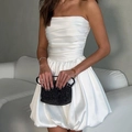 Detail view of white strapless satin mini dress with elegant bubble hem and ruched waist - XS / White