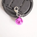 Macro shot of rose red metal round bell charm with a silver lobster clasp attachment - Rose Red