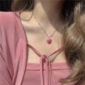 Detail of a pink heart pendant on a thin beaded chain worn by a female model - Pink Heart Bead Chain Necklace