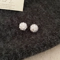 Detailed macro of clustered pearl flower studs on grey knit fabric with a vintage card - 50# White Flower Cluster Pearl Silver Earring Post