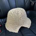 Detail of beige crochet bucket hat with hollow-out knit texture on a black seat - M (56-58cm) / Camel