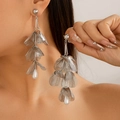 Silver ginkgo leaf dangle earrings with drop pearl detail on model neck close-up - Hollow Petal Pearl / Silver