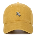 Close-up of mustard yellow washed cotton baseball cap with astronaut embroidery - Yellow