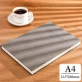 A4 taupe soft faux leather notebook 215x288mm on a wooden desk with a coffee cup - Ruled / A4-Grey