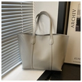 Detail shot of light grey soft leather tote bag showing large capacity and smooth texture - Gray