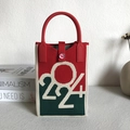 Red and green knit handbag with number 224 and love button on a minimalist desk - New Year Red Green Number Pattern