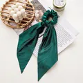Emerald green pleated velvet scrunchie with long ribbon streamers for elegant hair styling - Glossy Green Streamer