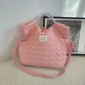 Detail of pink heart quilted canvas tote with brand embroidery and striped handle - Heart Pink