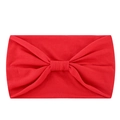 Detailed close-up of a red elastic yoga headband featuring a classic central bow knot - Red