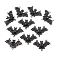Detailed view of ten black electrophoretic bat pendants with wing textures for DIY jewelry - Style 3 30x47mm