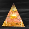 Detailed close-up of a resin pyramid with pink crystal ball and golden lotus base - QK35 Clear Quartz Watermelon Red / 6cm