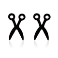 Macro detail of minimalist black scissor-shaped stud earrings on a reflective white background - 079 Scissors / Black