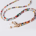 Detail of colorful faceted beads and faux pearls with gold lobster claws on a glasses chain - Colorful