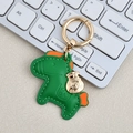Leather horse keychain in green and orange with golden ring and money bag charm - Mini / Green