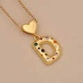 Macro shot of gold heart necklace with colorful zircon-encrusted letter D pendant - Letter D / Gold