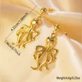 Golden octopus dangle earrings detail with measurements on elegant champagne satin fabric - Stainless Steel Octopus Dangle