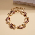 Détail des maillons en émail floral doré avec zircons blancs et chaîne réglable - Bracelet Rouge