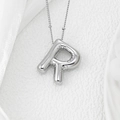 Macro detail of puffy silver balloon letter R pendant with textured fold effects - Letter R Pendant
