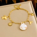 Gold stainless steel starfish and seashell pendant bracelet on champagne leather base - Turtle Scallop Fish Tail Style (B1728)