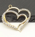 Macro shot of gold-plated hollow heart pendant with sparkling crystals for jewelry DIY - Large Heart Pendant / Gold