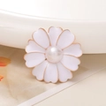 Macro shot of white enamel flower charm with golden edges and a central pearl detail - Pearl Center Flower / White