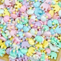Macro view of macaron-colored resin tulip and elephant DIY craft accessories - Crown