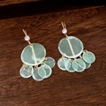 Detail of light green star pearl earrings with cubic zirconia on a wooden tray - Light Green Translucent Disc Style (13#)