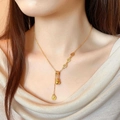 Gold plated sweater necklace featuring lucky gourd pendant and fú character medallions - Gold Gourd