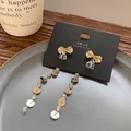 Eleganti orecchini a fiocco in oro argento 925 con nappe di cristallo su espositore - E2987 Oro Fiocco Pezzo Rotondo Nappa