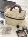 Quilted beige cosmetic bag featuring embroidered brown bows and a plush top handle - Coffee Bow Makeup Bag