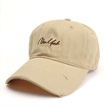 Close-up of khaki baseball cap with New York embroidery and distressed ripped brim details - Khaki