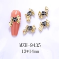 Detailed view of 13x14mm golden alloy bow nail art charm with a dark grey heart crystal - Gold Bowknot Grey Heart(9435)
