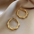Chic twisted gold hoop earrings with polished metal texture on elegant silk background - A181 Gold Twisted Hoops
